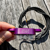 a purple SON brand rack mounted bike light, with a black cable